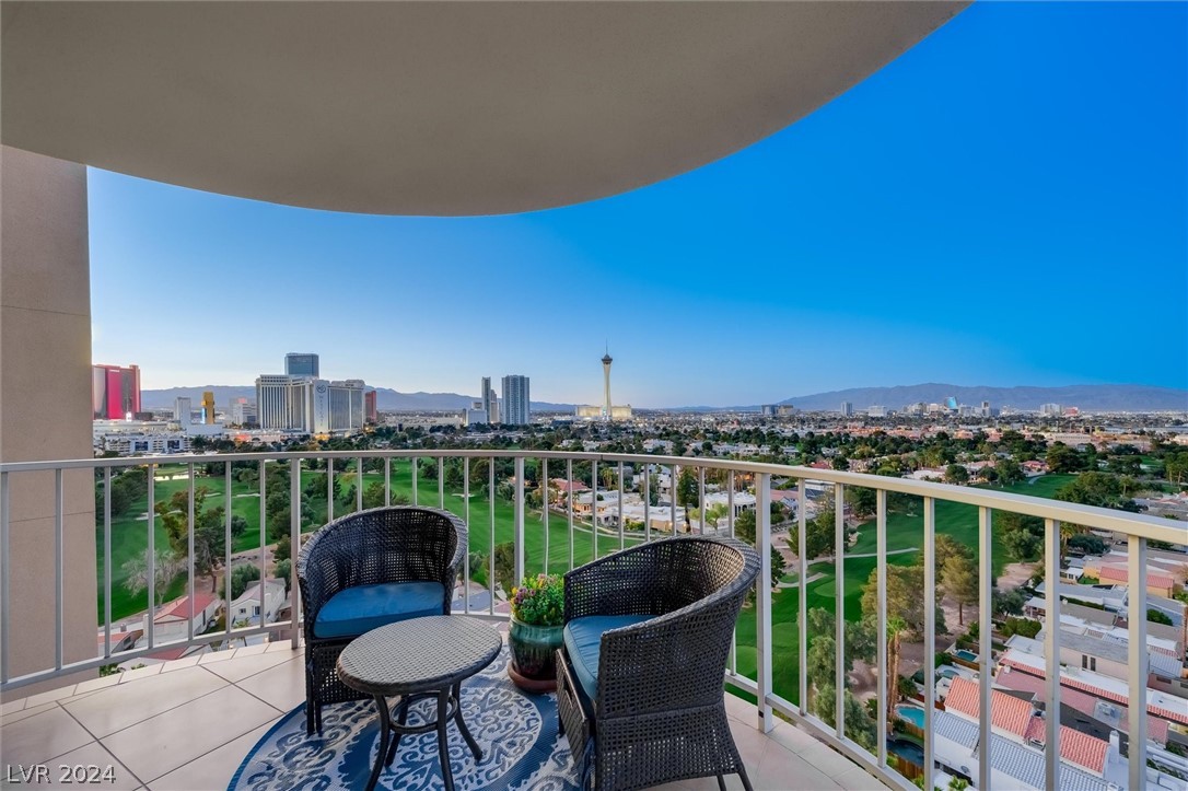 Experience the exclusivity of living in this 3 Bedroom 3 bath high-rise in the Las Vegas Country Club with guarded gates, just a 5-minute drive to the Strip. Enjoy breathtaking views of The Las Vegas Strip, downtown and the mountains from the 19th floor, you will find an expansive wrap-around balcony. This meticulously remodeled unit features custom cabinets, numerous built-ins, tile floors, quartz countertops, built-in storage, and custom closet. Additional upgrades include a wine cooler, separate freezer, and electric shades, newer upgraded AC unit and soft water.  The list goes on and on you have to see it for yourself!