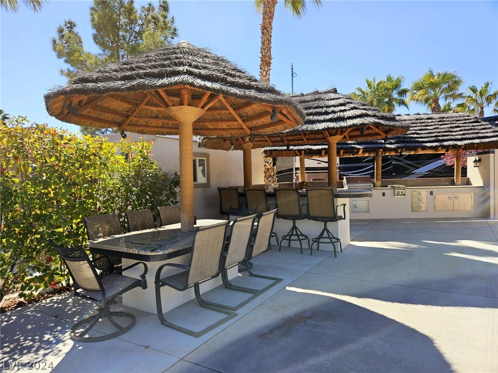Located within the Class A Las Vegas Motorcoach Resort, this site is ready to move in and enjoy! Amazing fully built site with multiple palapas including a large rectangle palapa with a full outdoor kitchen with granite counters, bar area, dining area, and two roll up door storage areas with a washer and dryer.