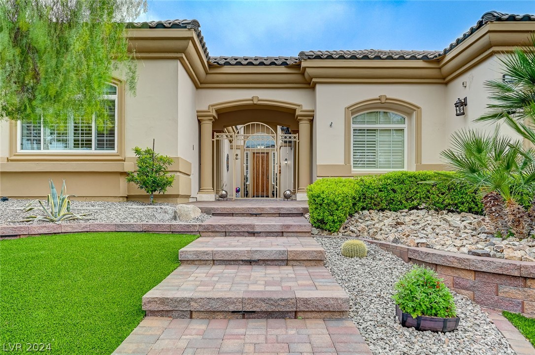 The beautifully landscaped front yard leads into the gated courtyard.
