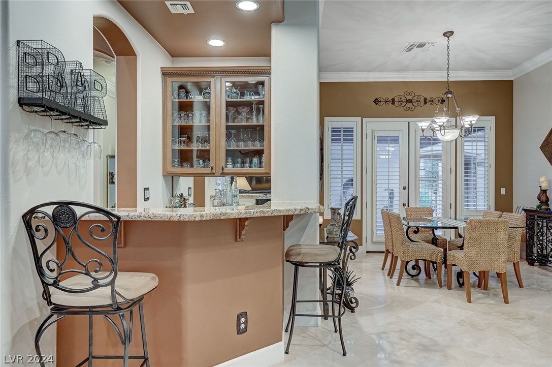 The elegant bar area sits between the kitchen and the dining area.
