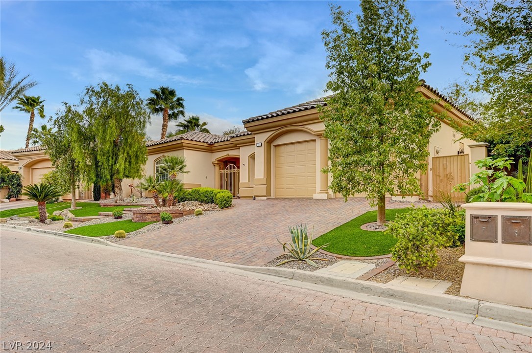 Luxuriously paved community streets lead to this beautiful Mediterranean-style home.