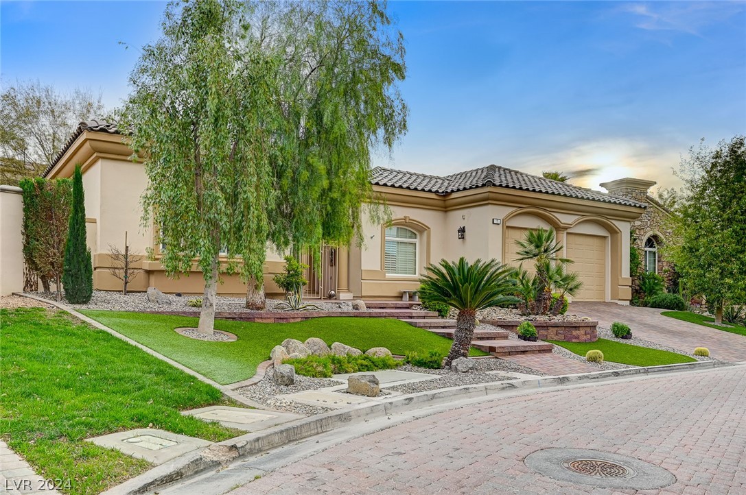 The mature landscaping in the front yard is meticulously maintained.