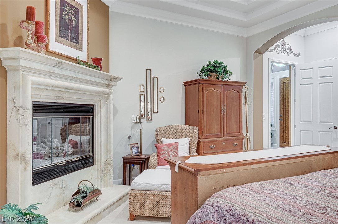 An elegant fireplace in the primary bedroom provides warmth and ambiance.