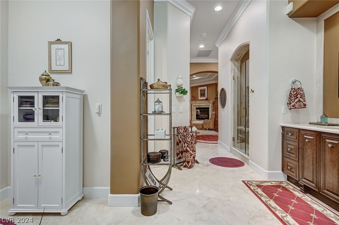 The primary bathroom has a private exit to the backyard for convenient access to the Jacuzzi. The door is not visible here, but it is in the alcove to the left near the white cabinet.