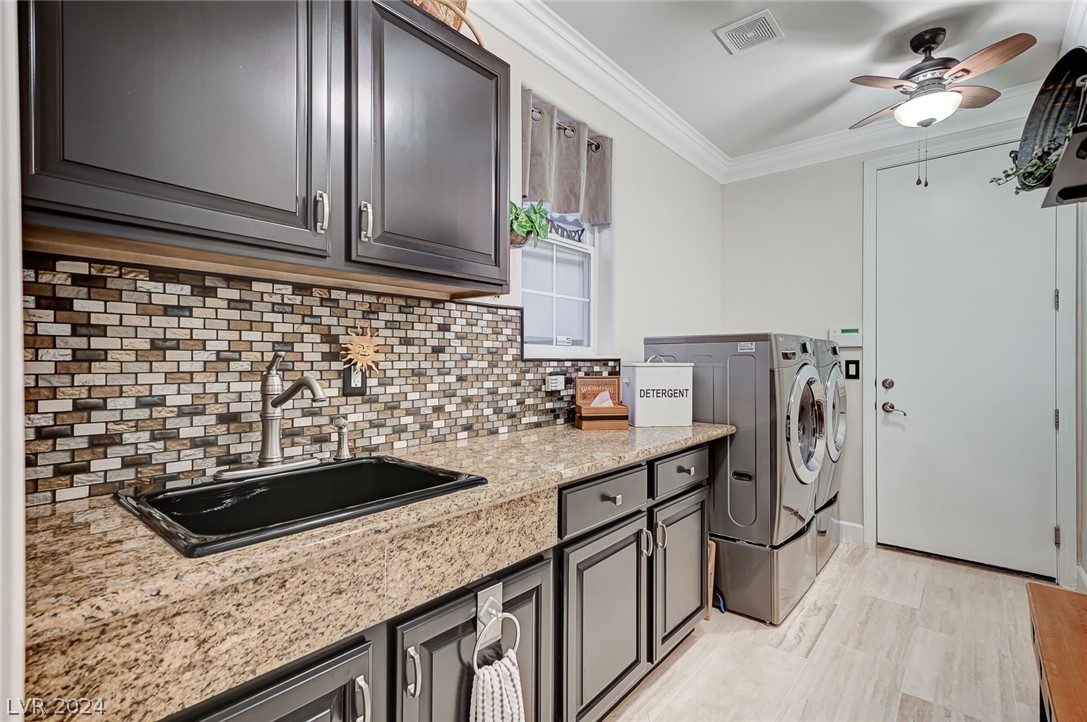 The laundry room has been remodeled, including new backsplash, countertop, utility sink faucets, and ceiling fans.