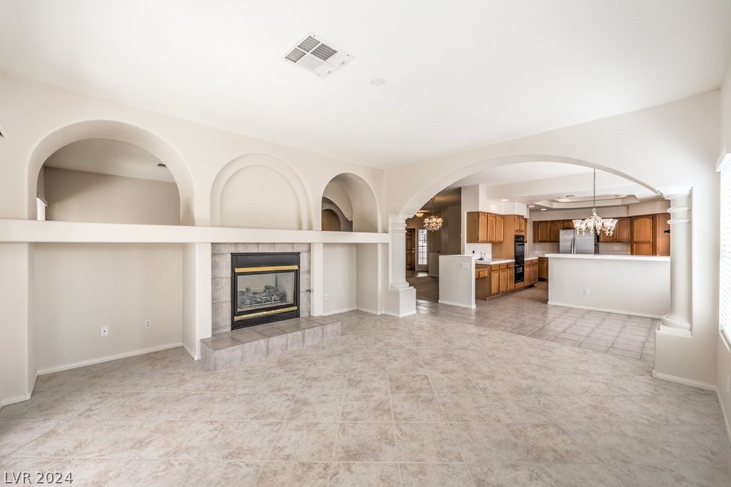 Separate Family Room with Tile Flooring shares the 2-Way Gas Fireplace