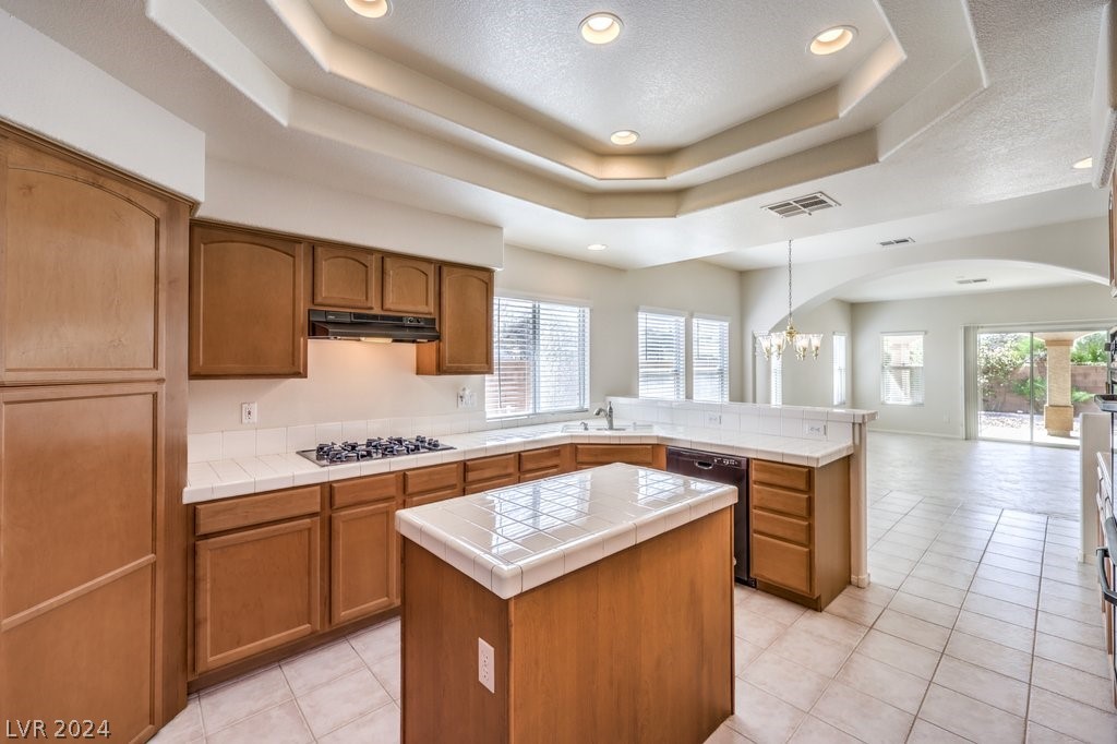Island Kitchen with Breakfast Bar, Nook, W/I Pantry, Menu Desk, Recessed Lighting, Tile Flooring, B/I Double Oven, Gas Cooktop, Dishwasher, and Refrigerator