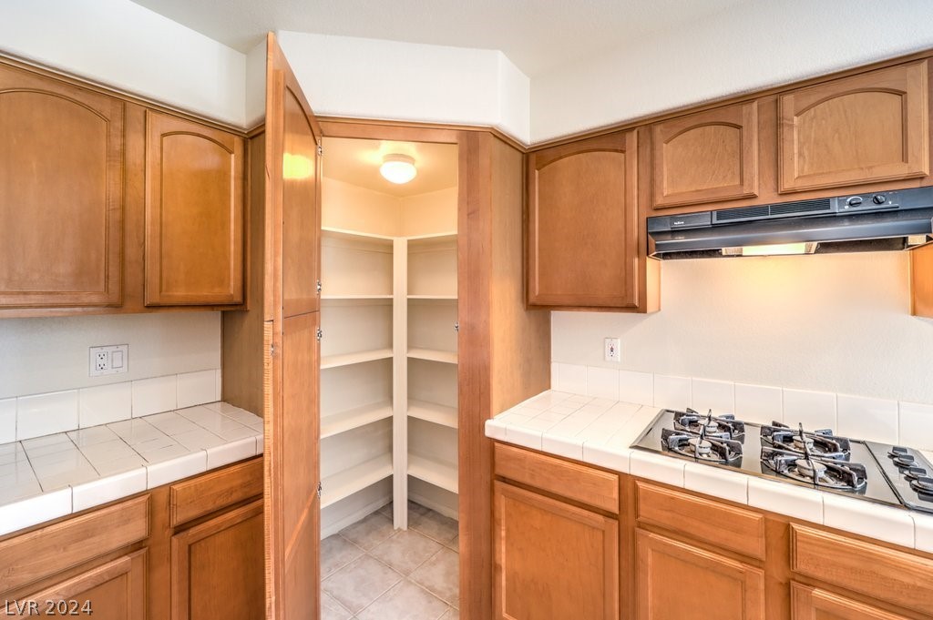 Island Kitchen with Breakfast Bar, Nook, W/I Pantry, Menu Desk, Recessed Lighting, Tile Flooring, B/I Double Oven, Gas Cooktop, Dishwasher, and Refrigerator