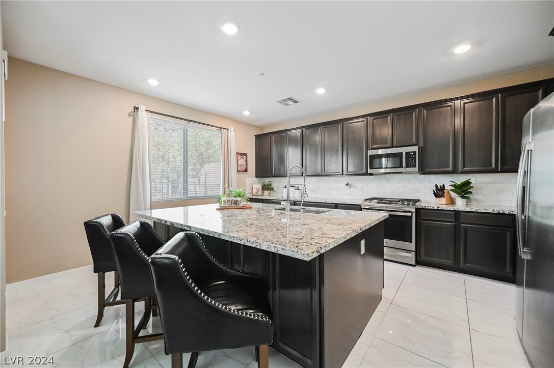 The kitchen is the heart and hub of this home with a large island and plenty of gathering and work space.