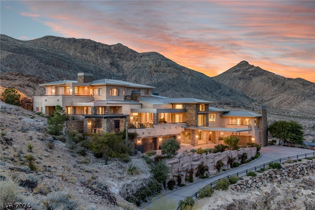 Spectacular home perched high above the city with stunning 360-degree views of The Strip, Vegas Valley & surrounding mountains from every window. This nearly 15,000 sq ft home recently underwent an exquisite $6 million renovation of the finest standard and is in one of the most prestigious neighborhoods in Vegas: triple gated The Pointe enclave of The Ridges. Enjoy the utmost privacy, backing to the mountains & no surrounding neighbors. Whether you’re a true home cook or prefer a private chef, the kitchen has it all: double islands w/waterfall onyx, 3 full ovens, commercial walk-in fridge/freezer, steamer, deep fat fryer & more. Seamless indoor/outdoor living at its best with multiple pocketing door systems, huge balcony w/dining & full outdoor kitchen. Gorgeous primary suite w/more views, two enormous closets, lounge, sauna, yoga studio, steam shower, soaking tub & private outdoor bath. Other features: state-of-the-art movie theater, game room, loft area, neg-edge pool & much more.