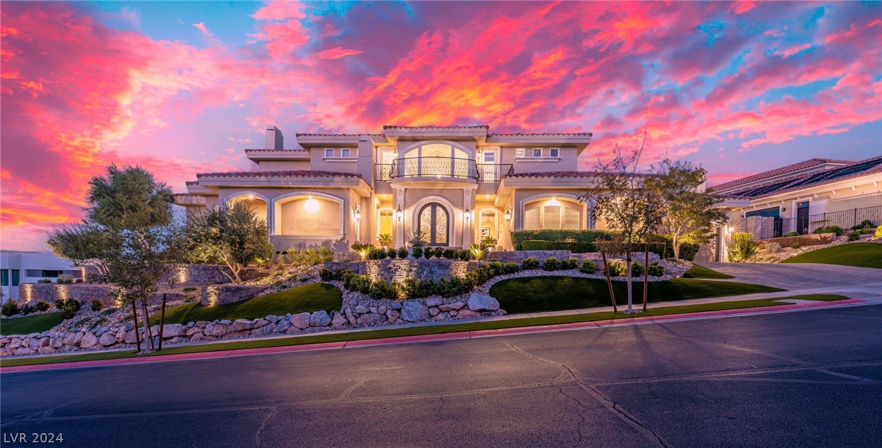 Immerse yourself in luxury with this custom, 3-story home in the prestigious Seven Hills. Spanning 6,970 sqft on a 0.55-acre lot, it offers panoramic views from the mountains across the Rio Secco Golf Course to the Las Vegas Strip. Featuring 4 bedrooms, 6 bathrooms, and a 4-car garage, the home combines elegance with timeless style. The primary suite includes a fireplace and a spa-like bathroom with heated floors. Amenities include marble floors, an elevator, home theater, climate-controlled garages, and a chef’s kitchen with high-end appliances. Outside, an infinity pool, spa, putting green, and built-in BBQ with pizza oven make it perfect for entertaining. With multiple balconies and luxurious upgrades, this estate is a prime opportunity to own a piece of paradise in Seven Hills.