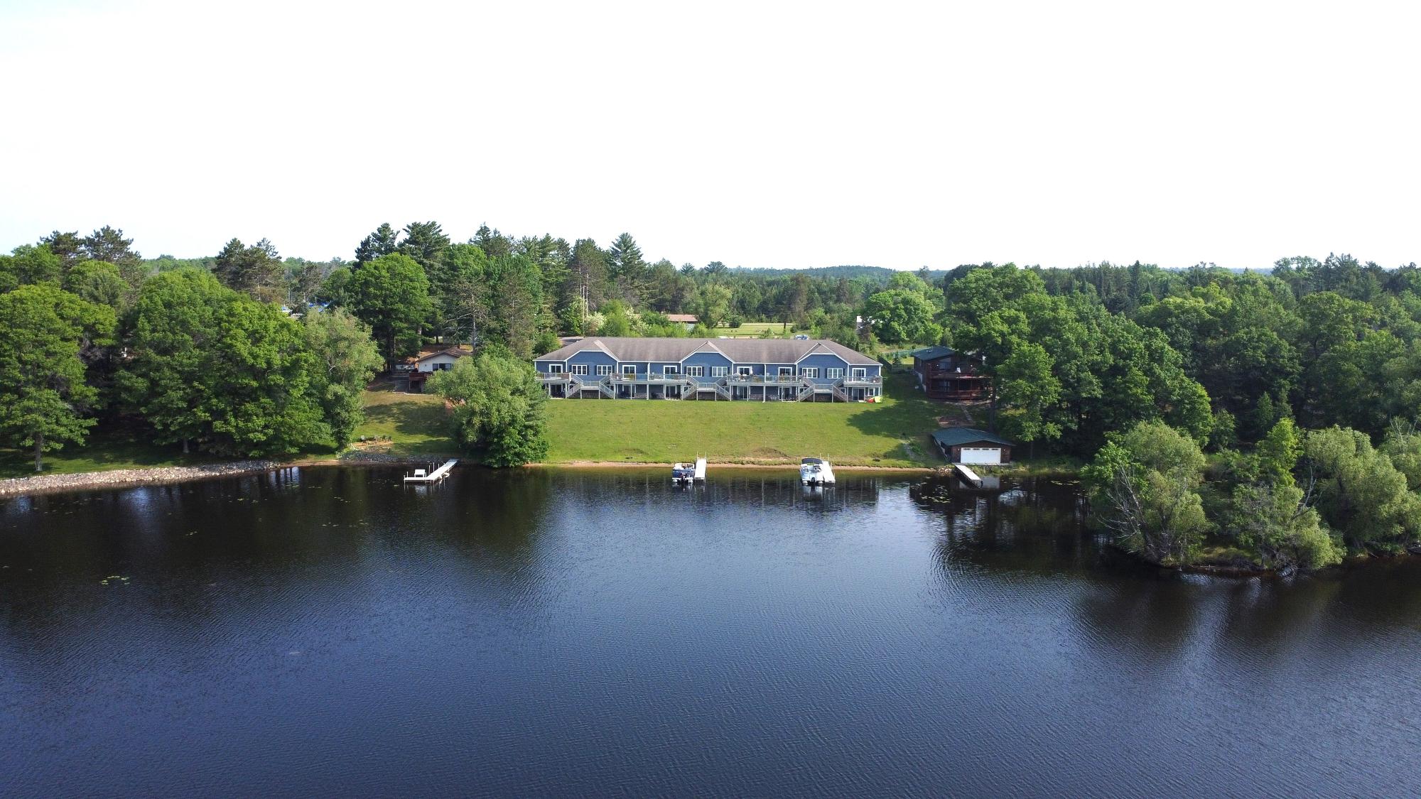 LAKE NOKOMIS INVESTMENT OPPORTUNITY! Discover an exceptional investment opportunity on the beautiful Lake Nokomis Chain, offering over 4,000 acres of recreational paradise. This property features six fully constructed waterfront condos and one standalone house, all currently fully rented with a strong occupancy history for immediate income stream. Each luxury waterfront condo unit consists of 3 bedrooms / 3 bathrooms open-concept living with gas fireplaces granite countertops. Walkout lower levels with kitchenette, family room, bedroom, and bath. Expansion potential, frost walls already poured for six additional units ready to boost ROI or create a storage facility for additional revenue. Exceptional boating, fishing, Utv/Atv trails and snowmobiling. Popular taverns, restaurants near by. Whether you're seeking a stable income-producing property or a development opportunity with major upside, this offering checks all the boxes. Call Today to set up a showing. Take advantage of the New Tax Law with Major tax Deductions. Plus bonus depreciation. "ALL MEASUREMENTS ARE APPROXIMATE. BUYER TO VERIFY ALL DATA WVIC owns the first 30' from the high water mark.