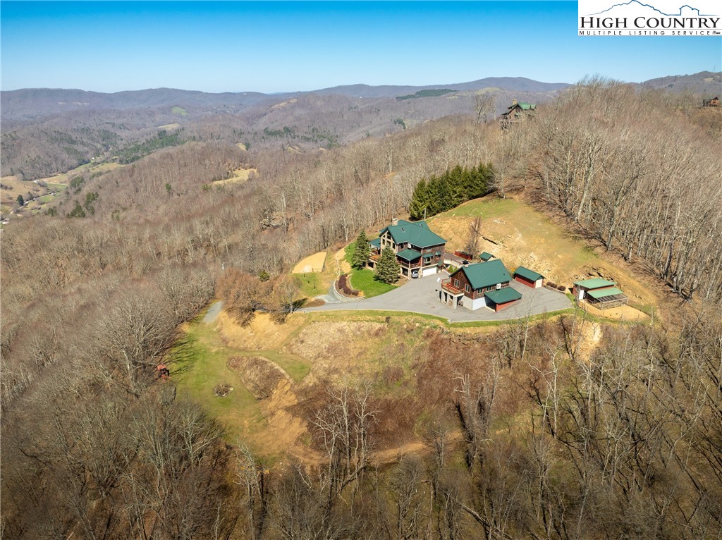 Amazing home with panoramic, year-round views of Stone, Beech, Grandfather Mountains, and more! No detail was overlooked when building this home, which includes a 3,818 sq ft 4BR/4BA main home plus an additional 1BR/1BA 794 sq ft guest house, totaling 4,612 heated sq ft of living area and 5BRs/5BAs for the property!  From the 16" ICF lower level walls to the top of the line Galvalume roof and everything in between, there are too many features to list (see documents for full list). Meticulously maintained with major upgrades to the heating system, hot water, heat and air, and more. In addition to the 4BR/4BA main home, this property includes a guest house complete with basement garage and 794 sq ft of extra living area that includes a bedroom, bathroom, living room, and kitchen. Radiant floor heating is found throughout the garage space and living areas in both homes. This 11+ acre property offers a second build site that could be used to build another home, barn, storage shed, etc. Also included are: whole house generator, chicken coop, storage shed & more flat areas for a garden, recreation, outdoor storage & more. Propane will be prorated at closing.