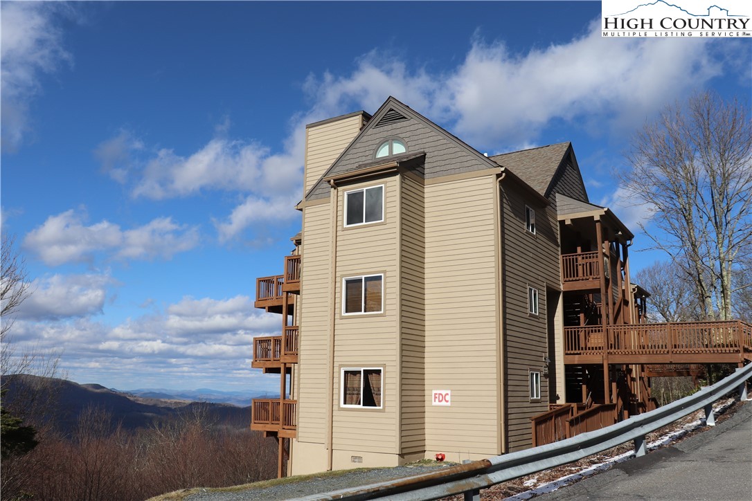 Welcome to this Loft condo with short & long-range views of Sugar Mountain, Banner Elk & Beech Mountain! This is an end unit located in desirable Sugar Ski & Country Club with the following amenities: Club House with indoor heated pool, sauna, hot tub, fitness room, outdoor tennis/pickleball court & electric car charging station available for fee. Sugar Ski is a condominium resort with ski-in / ski-out from Oma’s Meadow. 2022-2023 updates to this Loft include luxury vinyl plank flooring throughout the condo’s first level, smooth ceilings, new sheetrock in the bath, painted interior, electric fireplace insert, butcherblock counter & kitchen faucet, refrigerator, smooth ceramic glass surface range, counter microwave, Fisher & Paykel DishDrawer, bath vanity & faucet, light/fan, toilet, light fixtures in the dining, foyer & loft, new screen for skylight window, blinds & custom Hunter Douglas shutters for the half-arch windows in the loft. This turn-key unit includes furnishings and décor as seen. Water, sewer, cable and internet included in the HOA dues. Unit equipped with wet pipe sprinkler system. Agent is owner.