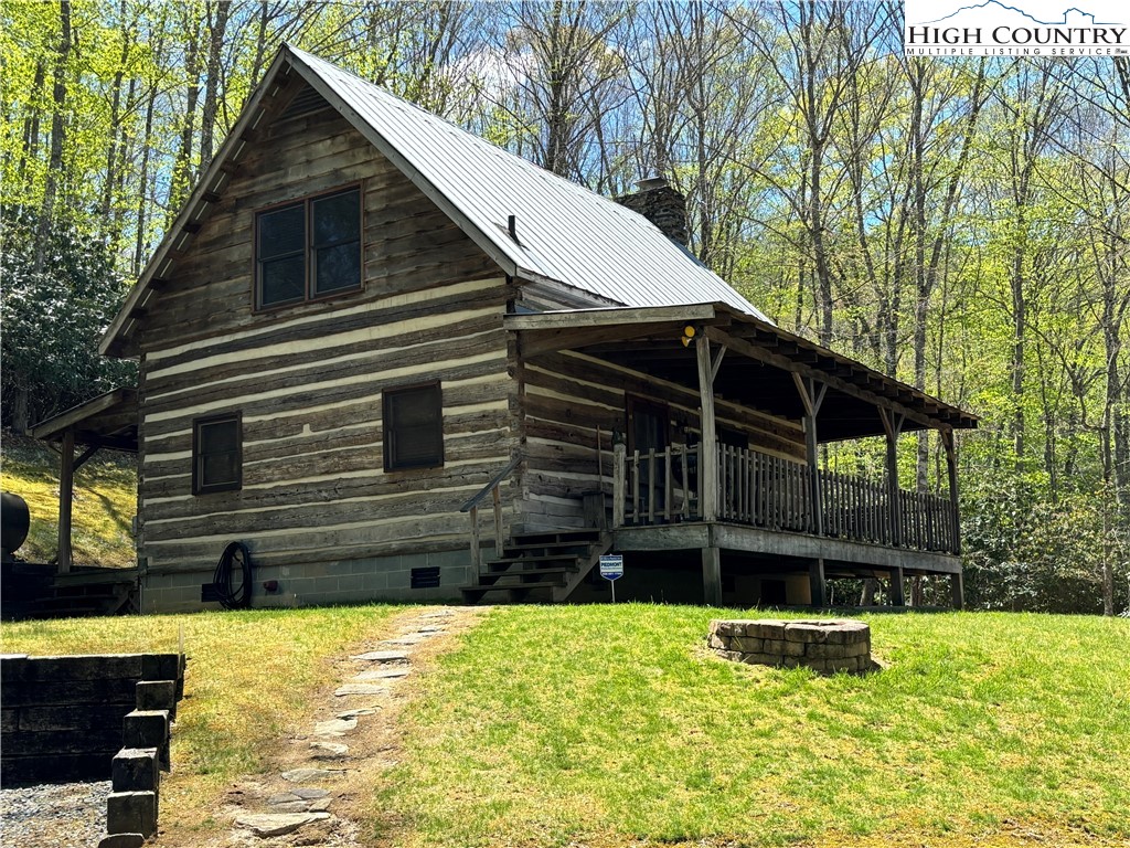This immaculately maintained antique-style log cabin on 10.4 unrestricted acres has lots to offer the buyer looking for a quiet retreat in the coolest corner of NC!  Centrally located in Ashe County, the home is only a short walk to the North fork of the New River and a short drive to the bustling little town of Lansing, and a 15-20 minute drive to all the amenities of West Jefferson. The cabin features wood floors, beautiful kitchen cabinets, a large stacked stone wood-burning fireplace, a large loft area that is currently being used as an additional sleeping area, and two covered porches. The property is a mix of hardwood forest and a pasture that would provide areas for a garden or farm animals. Silas Creek splits the pasture, providing water for animals or  the chance to hook a trout.  Escape the hustle and bustle and come take a look at this great property today! **NO DRIVE-BYS PLEASE**