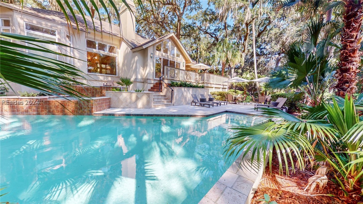 This dynamic, family-oriented home is located on an oversized .55 ac. corner lot in the prestigious Mariners section of Palmetto Dunes. It features a private spacious pool with cascading spa surrounded by multiple decks & gathering spaces.
Inside are two primary living areas, a gourmet kitchen with custom cabinets, high-end SS appliances & granite counter tops... a formal dining & eat-in kitchen provide seated dining for 20. 
There are 4 bedrooms and baths in the main home and an additional private mother-in-law suite with separate entrance featuring a complete kitchen, bedroom, bath and living space. 
Short walk to the beach.