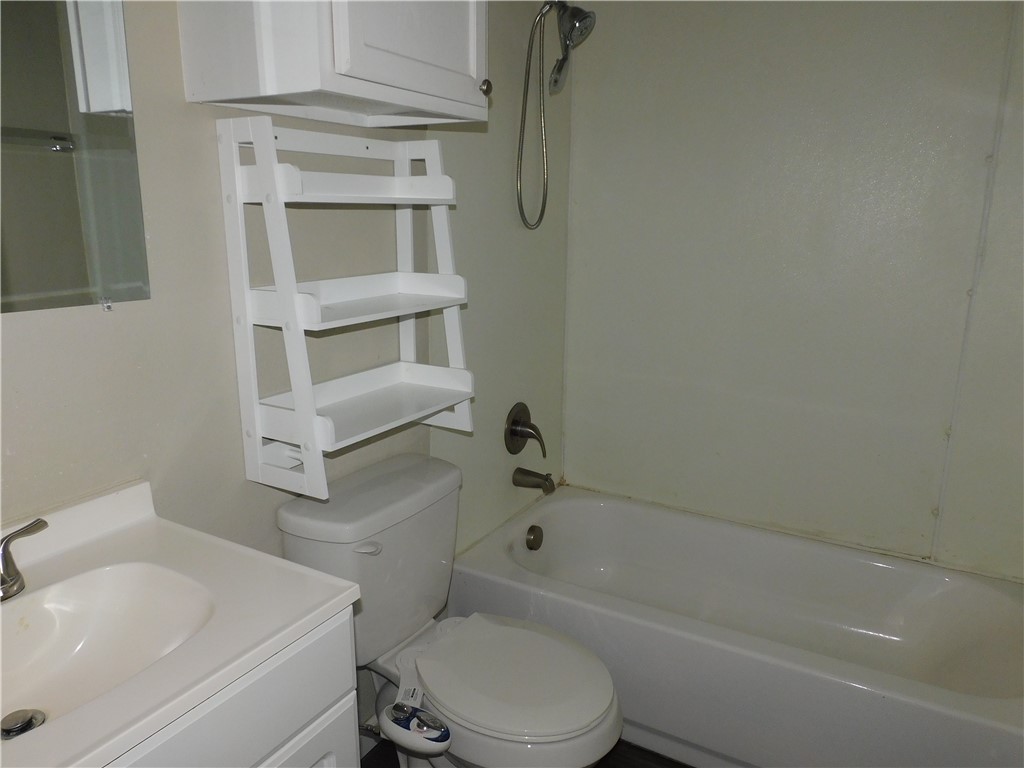 2321 NW 12th Street, #A, Oklahoma City, OK 73107 full bathroom featuring vanity, shower / tub combination, and toilet