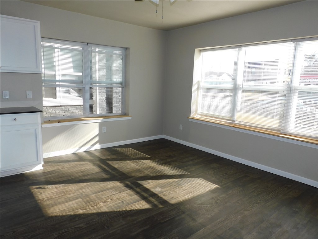 2321 NW 12th Street, #A, Oklahoma City, OK 73107 spare room with dark hardwood / wood-style floors