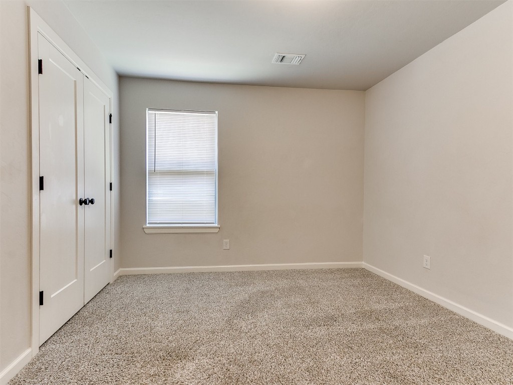 6604 NW 155th Street, Edmond, OK 73013 unfurnished room featuring light colored carpet