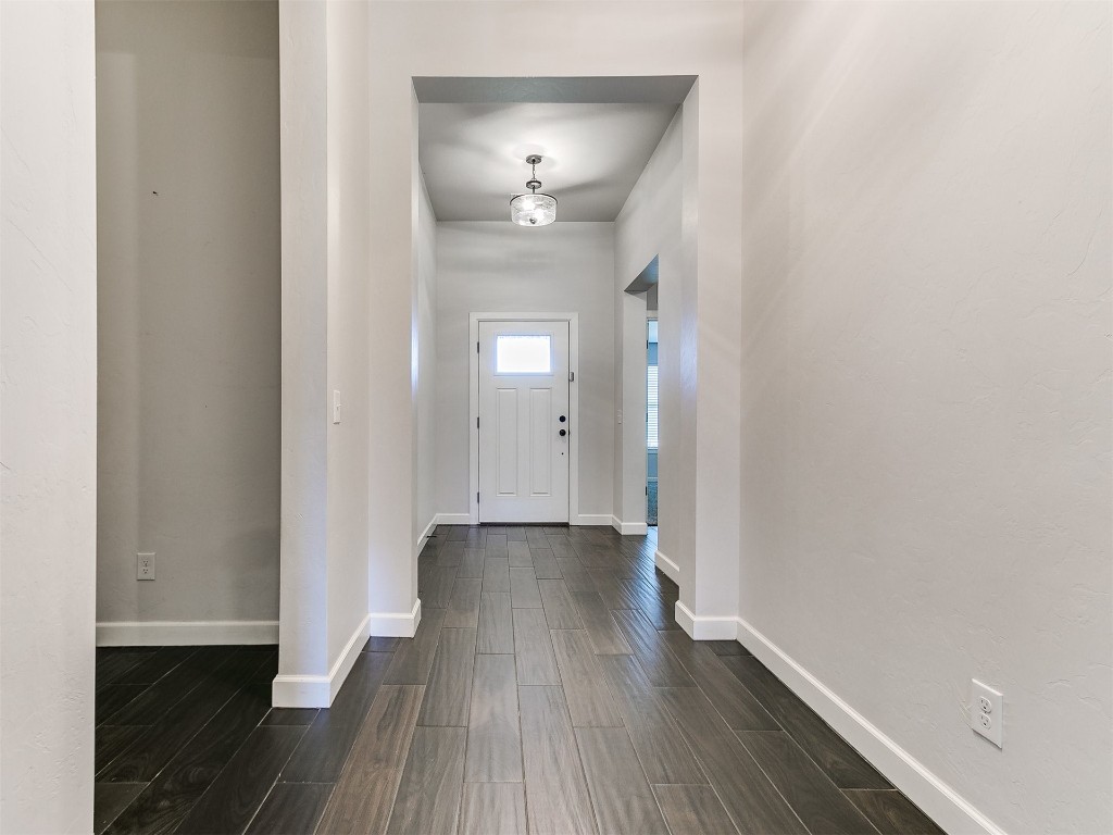 6604 NW 155th Street, Edmond, OK 73013 entryway featuring dark wood-type flooring