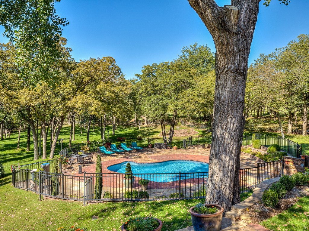 11425 Robinwood Lane, Oklahoma City, OK 73131 view of swimming pool with a lawn