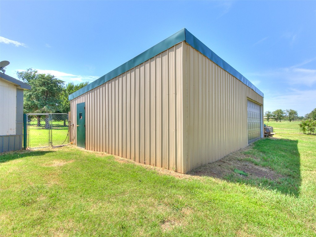 12677 NE 63rd Street, Spencer, OK 73084 view of outdoor structure featuring a yard and a garage