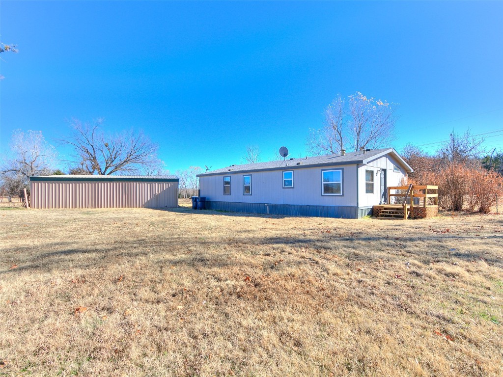 12677 NE 63rd Street, Spencer, OK 73084 back of property with a yard and a wooden deck
