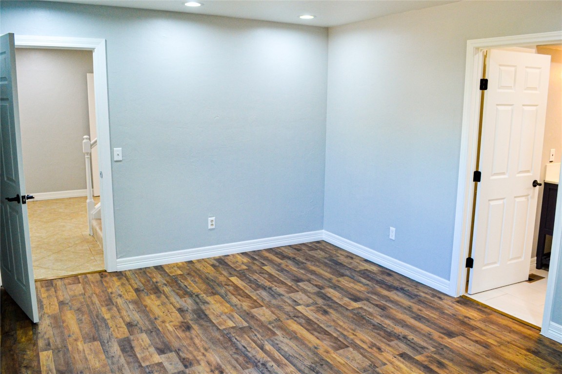6020 Queens Gate Road, Oklahoma City, OK 73132 unfurnished room with dark hardwood / wood-style flooring