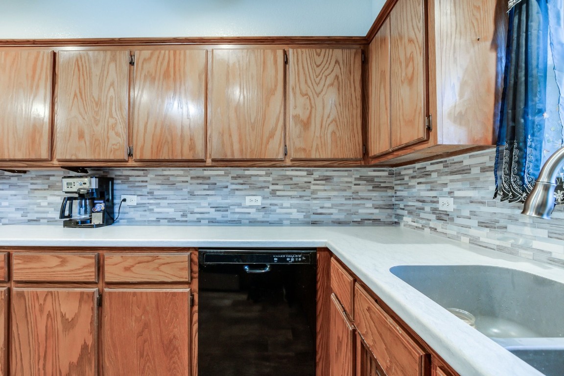 1310 Choctaw Trail, Blanchard, OK 73010 kitchen with sink, black dishwasher, and backsplash