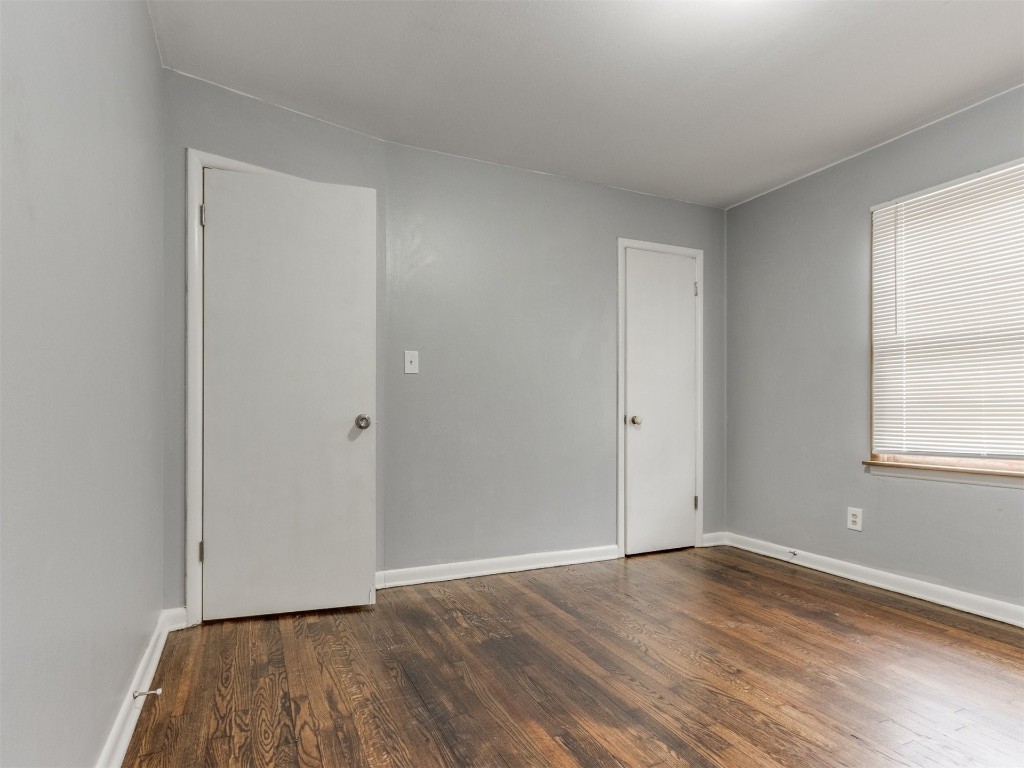 9312 NE 13th Street, Midwest City, OK 73130 spare room with dark hardwood / wood-style flooring