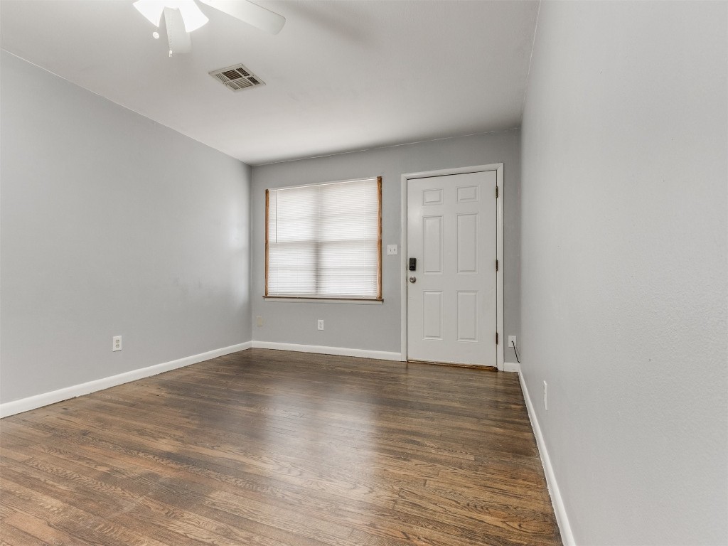 9312 NE 13th Street, Midwest City, OK 73130 spare room featuring dark hardwood / wood-style flooring and ceiling fan