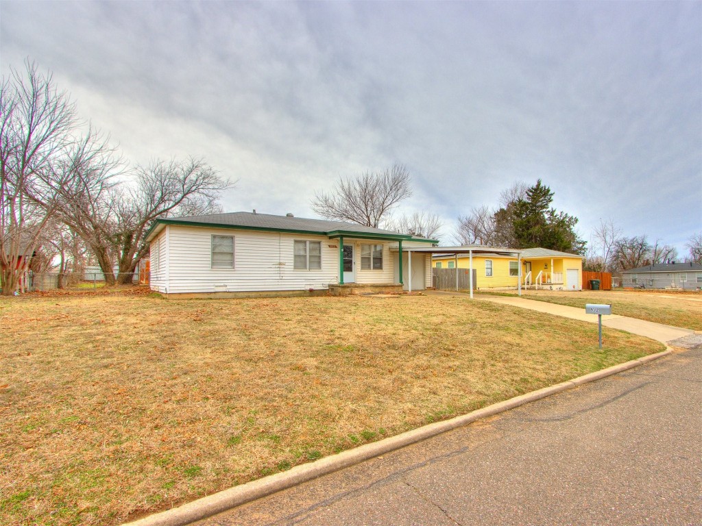 9312 NE 13th Street, Midwest City, OK 73130 ranch-style house with a front lawn