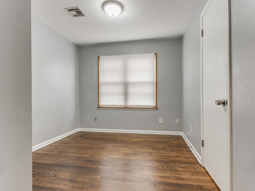 9312 NE 13th Street, Midwest City, OK 73130 empty room featuring dark wood-type flooring
