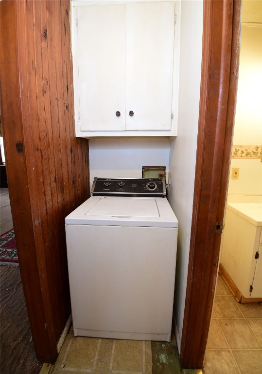 149 S 7th Street, Porter, OK 74454 washroom with cabinets, light tile flooring, and washer / clothes dryer