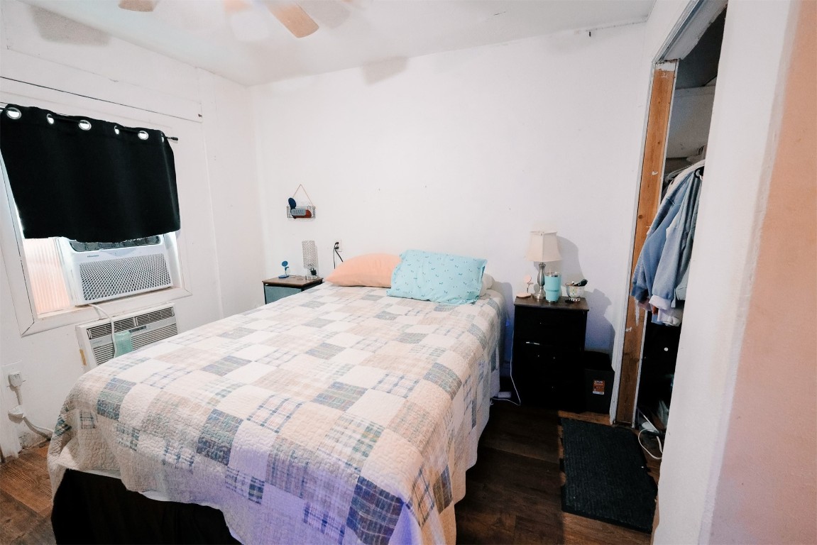 410 NW Oak Street, Kingston, OK 73439 bedroom featuring dark hardwood / wood-style floors and ceiling fan