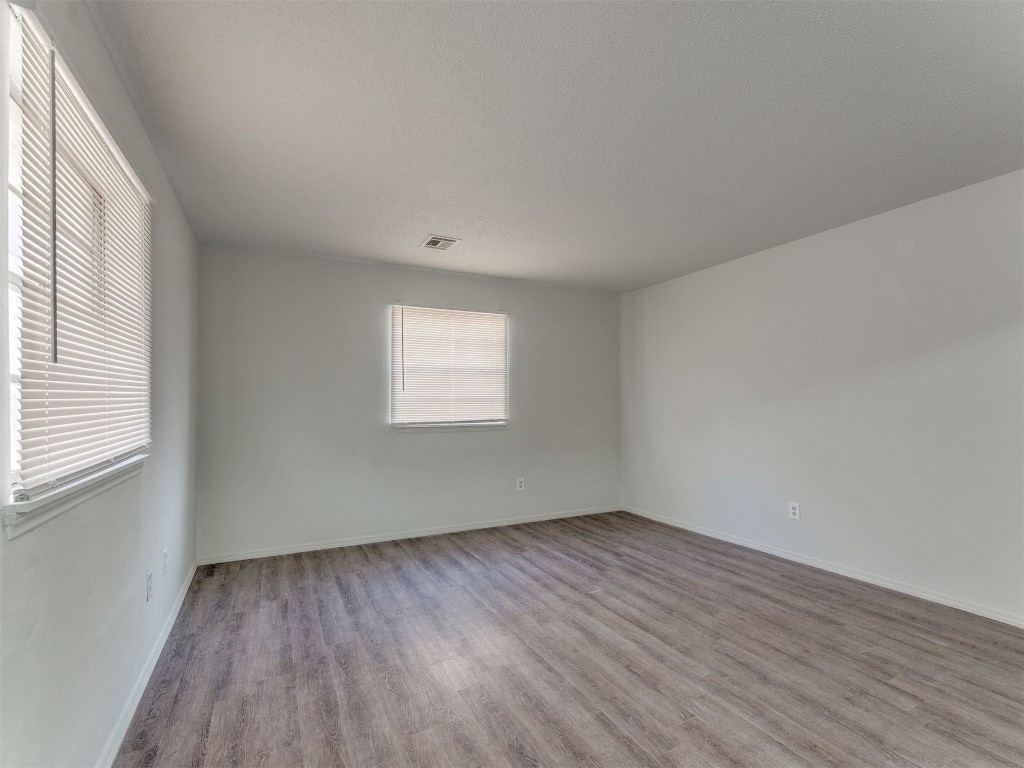 209 NW 80th Street, Oklahoma City, OK 73114 spare room with hardwood / wood-style flooring