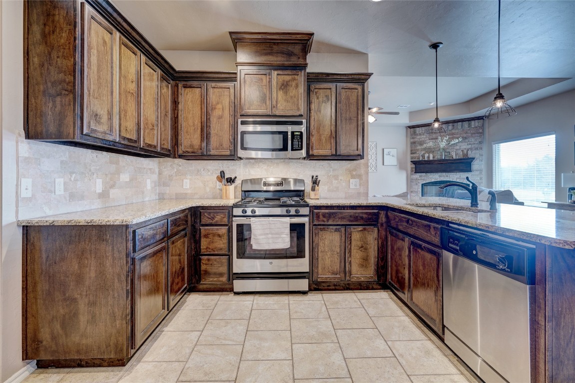 145 Oakridge Drive, Choctaw, OK 73020 kitchen featuring light tile flooring, sink, stainless steel appliances, and backsplash