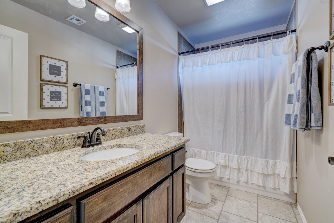 145 Oakridge Drive, Choctaw, OK 73020 bathroom with tile floors, vanity, and toilet