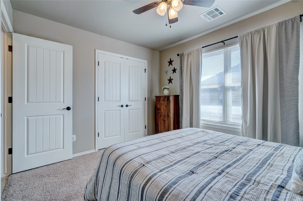 145 Oakridge Drive, Choctaw, OK 73020 carpeted bedroom featuring multiple windows, a closet, and ceiling fan