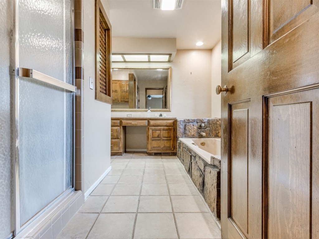 10717 Woodridden, Oklahoma City, OK 73170 bathroom featuring separate shower and tub, tile floors, and vanity