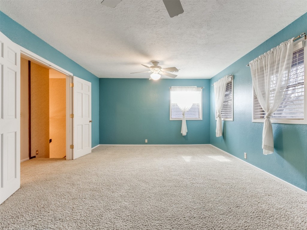 10717 Woodridden, Oklahoma City, OK 73170 unfurnished room with a textured ceiling, ceiling fan, and light colored carpet