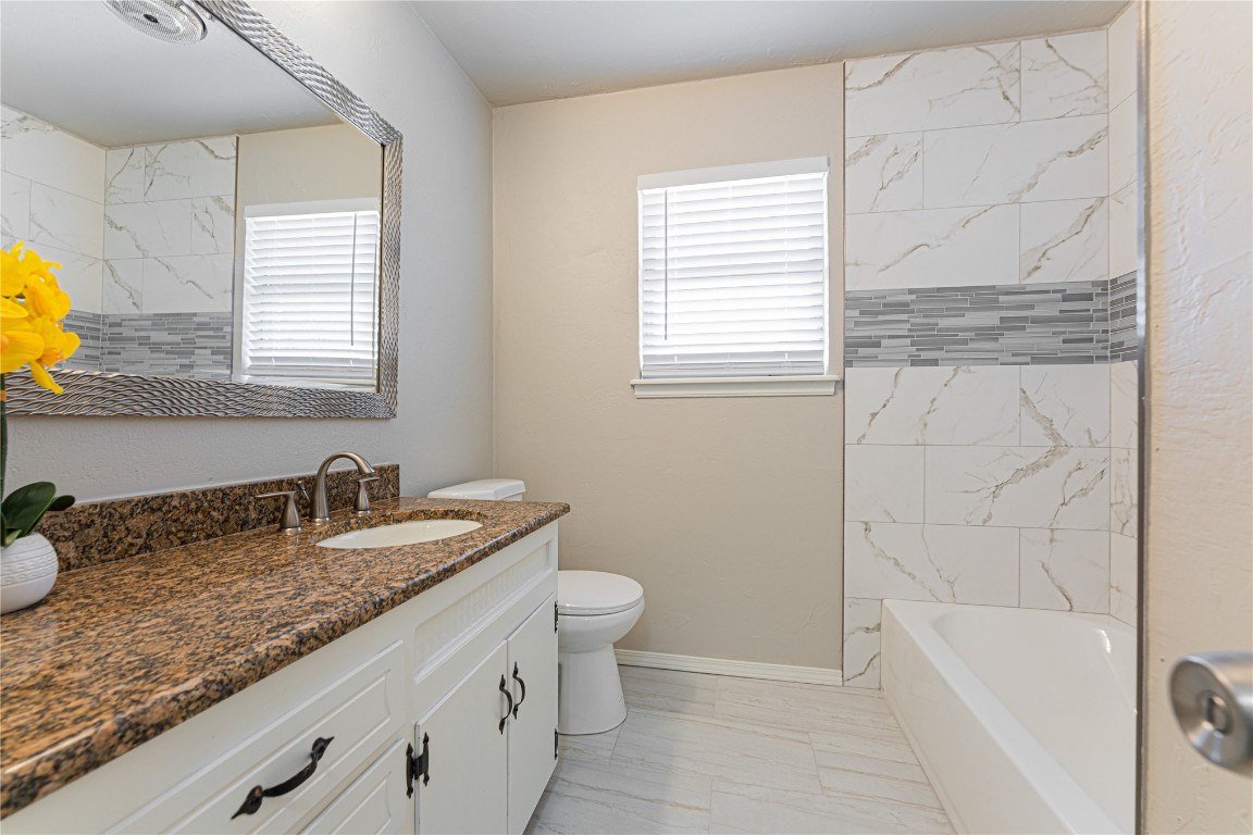 6004 S Dewey Avenue, Oklahoma City, OK 73139 bathroom featuring plenty of natural light, vanity, tile flooring, and toilet
