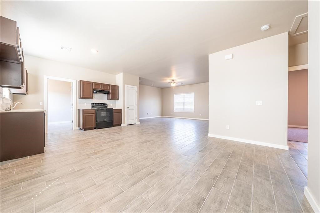 5231 Bluestem Avenue, Guthrie, OK 73044 unfurnished living room with light hardwood / wood-style floors