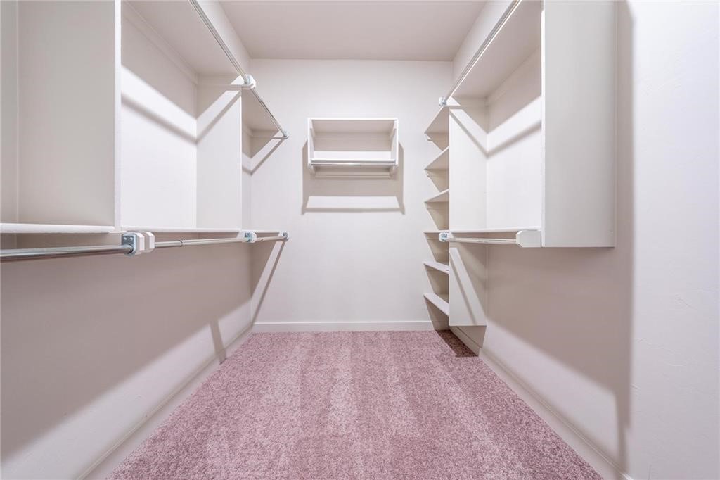 5231 Bluestem Avenue, Guthrie, OK 73044 spacious closet with light colored carpet