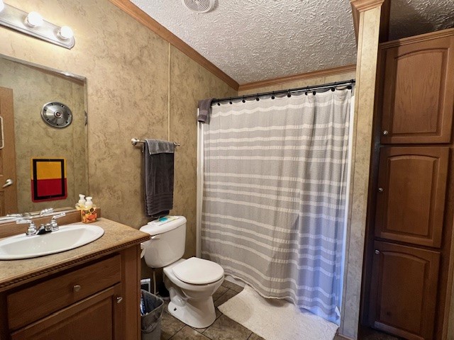 69473 Elmer Self Lane, Smithville, OK 74957 bathroom with a textured ceiling, vanity, ornamental molding, toilet, and tile flooring
