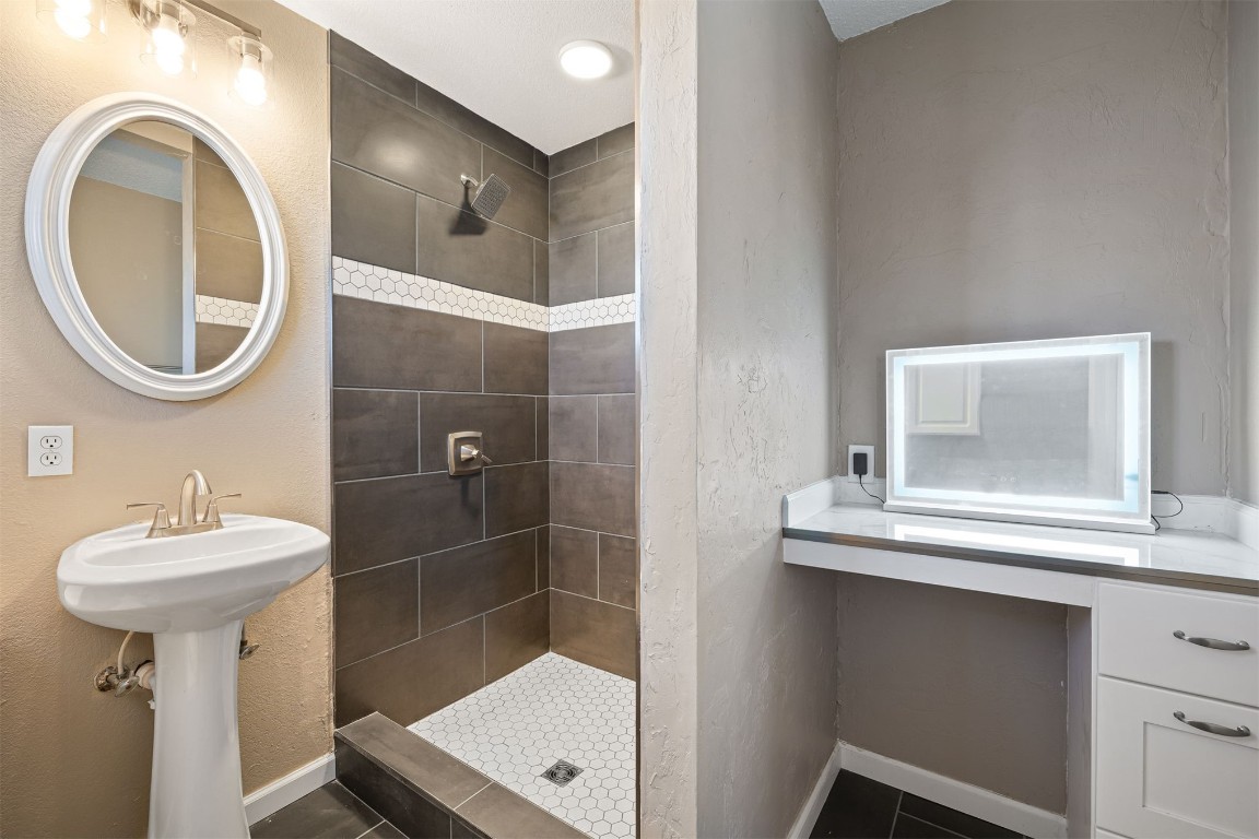 1813 NE 53rd Street, Oklahoma City, OK 73111 bathroom with tile floors and tiled shower