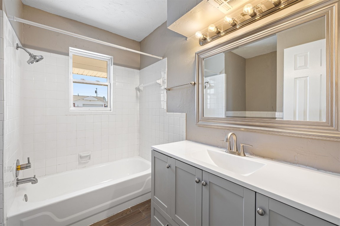 1813 NE 53rd Street, Oklahoma City, OK 73111 bathroom with vanity and tiled shower / bath