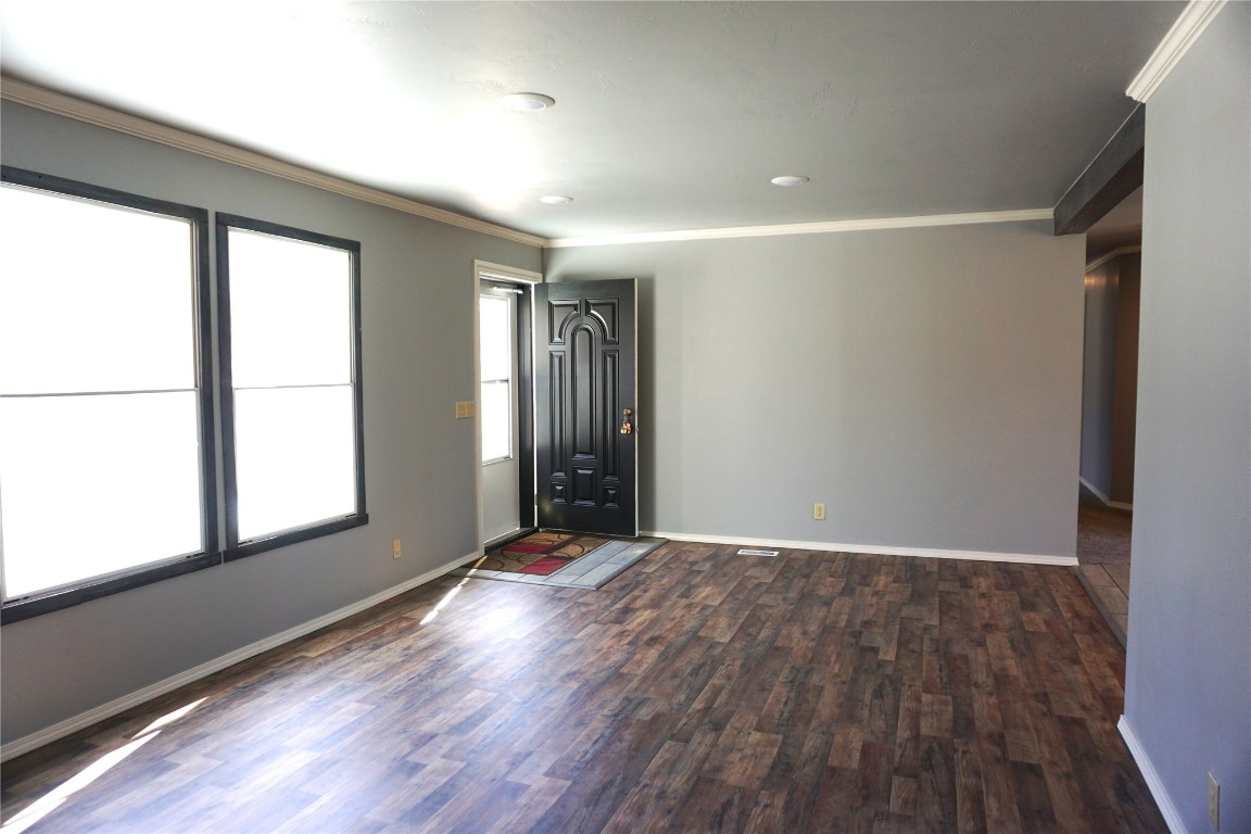 9201 Meadowbrook Lane, Guthrie, OK 73044 unfurnished room featuring dark hardwood / wood-style flooring and ornamental molding