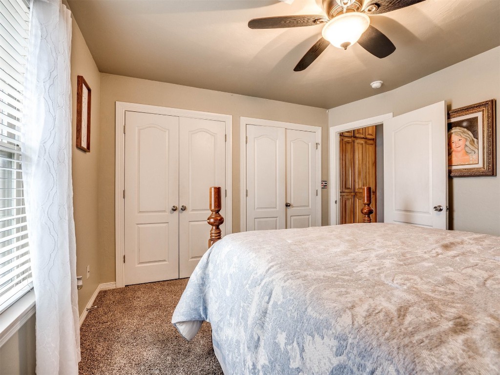 4216 Stardust Lane, Tuttle, OK 73089 carpeted bedroom featuring ceiling fan, multiple windows, and two closets