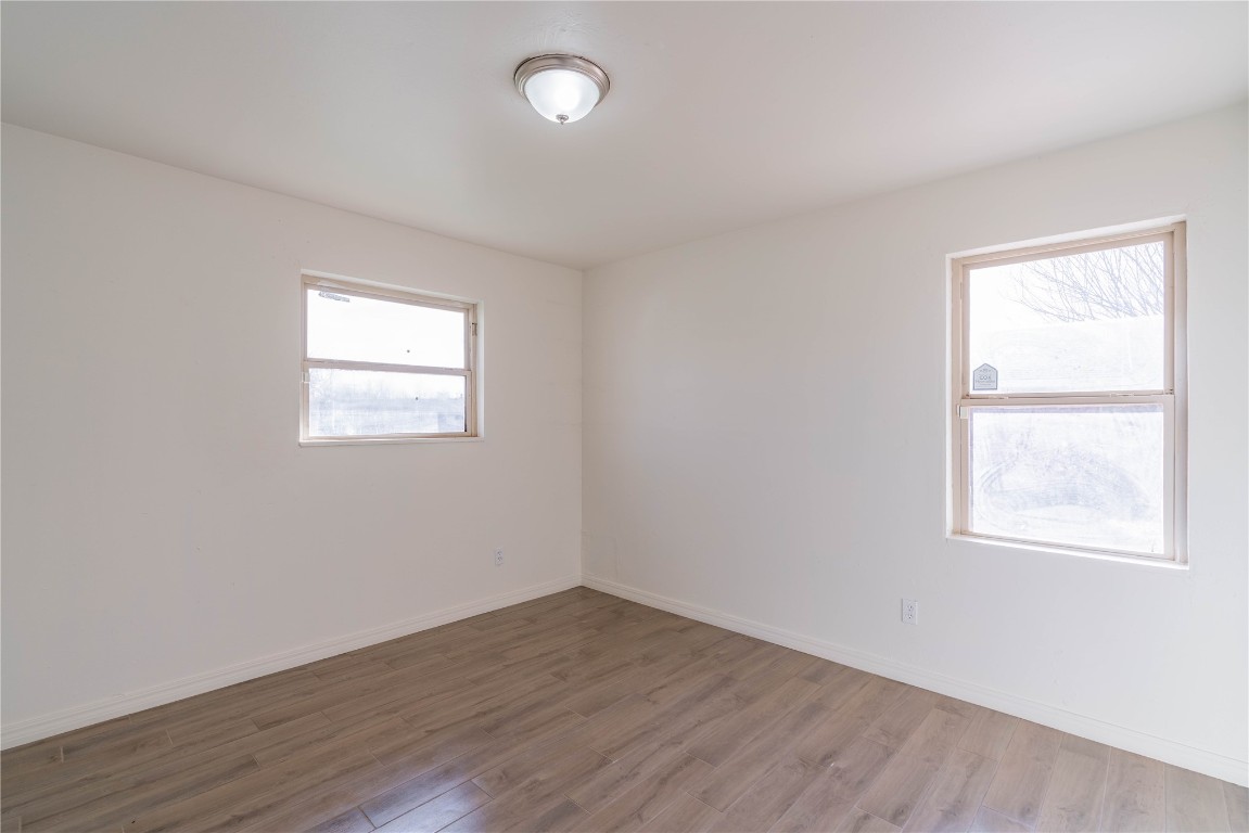 1417 NW 102nd Street, Oklahoma City, OK 73114 empty room with light wood-type flooring